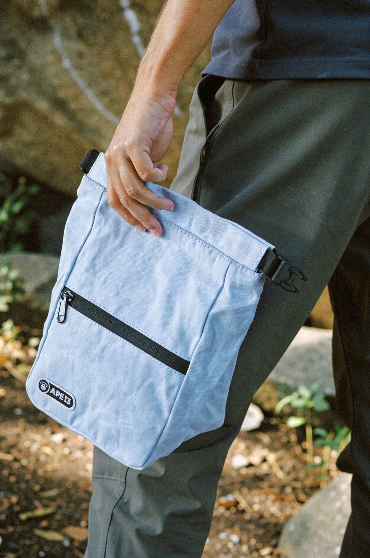 Close-up of a used APE13 chalk bag and climbing brush